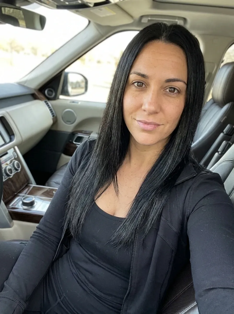 Original selfie input — woman in a black top, car selfie